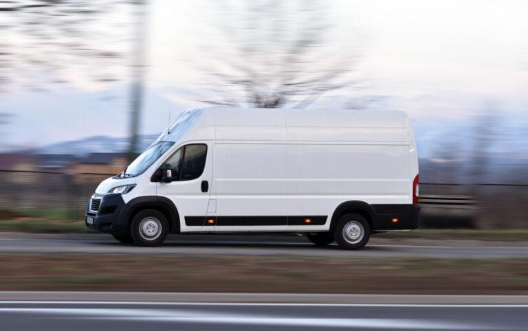 A FedEx truck speeding down the highway.