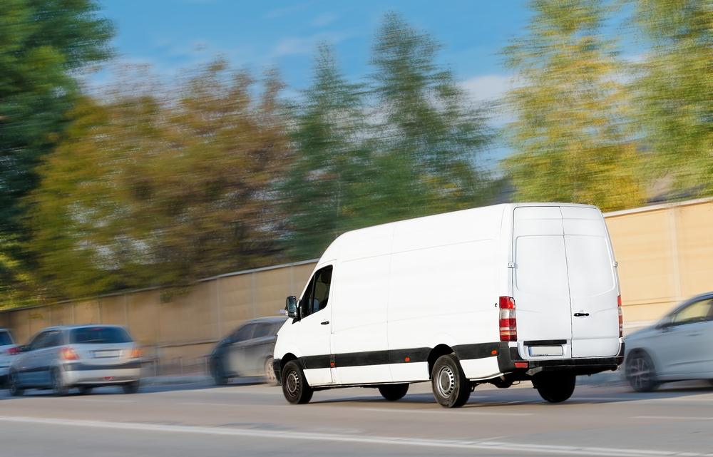 A UPS truck speeding down the highway.