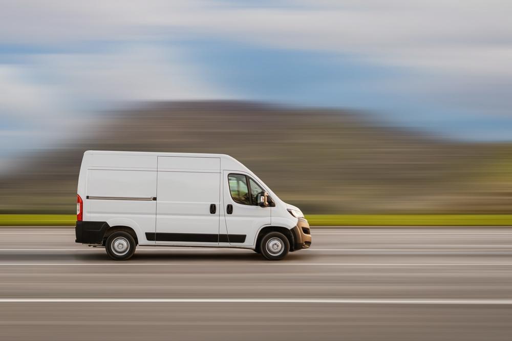 An Amazon truck speeding down the highway.