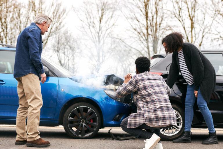 Three drivers examining a rear-end car accident. What are common injuries from rear-end car accidents?