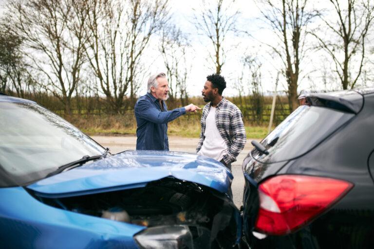 One man yelling at another uninsured driver after an accident.