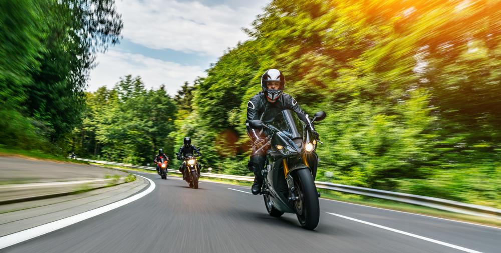Three motorcyclists ride down a quiet rural road while wondering whether you can file a motorcycle accident lawsuit without an attorney.