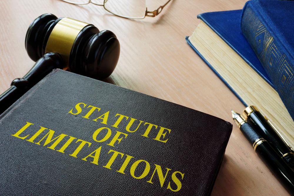 A gavel sits on a table next to a book titled “Statute of Limitations” that outlines the wrongful death statute of limitations in Utah.