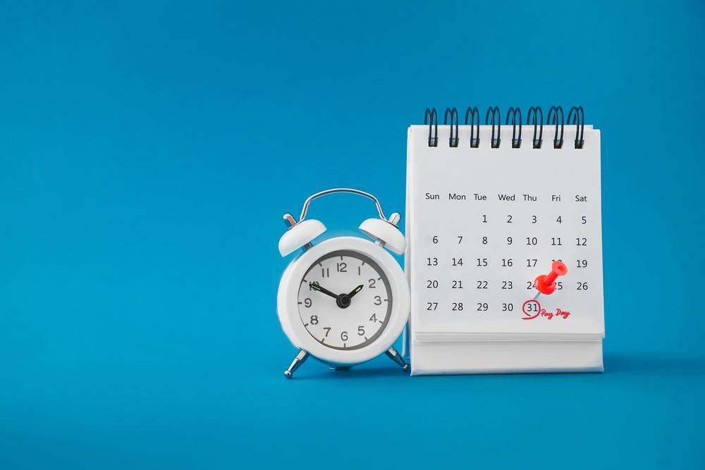 Blue backdrop with a white clock next to a white calendar with a date circled in red to symbolize the countdown to the car accident statute of limitations in Washington.