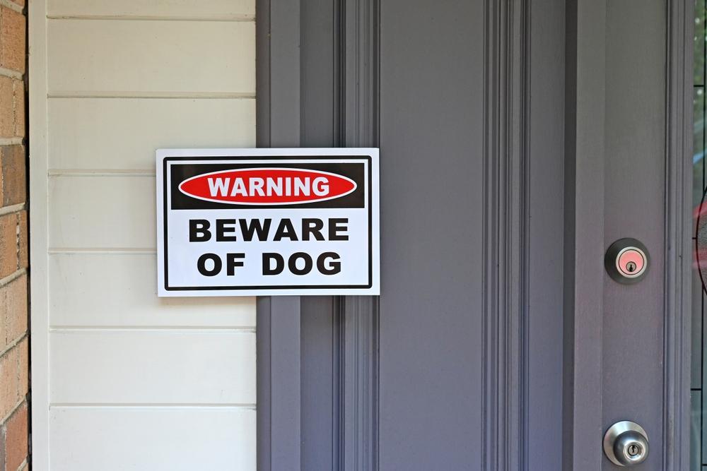A beware of dog sign on a house. If there was a beware of dog sign, can I still sue for a dog bite?
