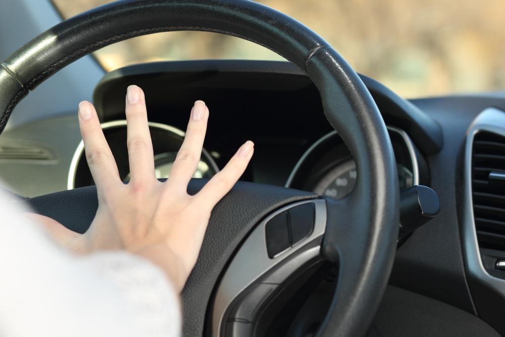 A teen driver honking the horn to avoid an accident during the 100 deadliest days of summer.