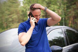A man on the phone after a car accident, asking if he can sue for more than policy limits in Utah.