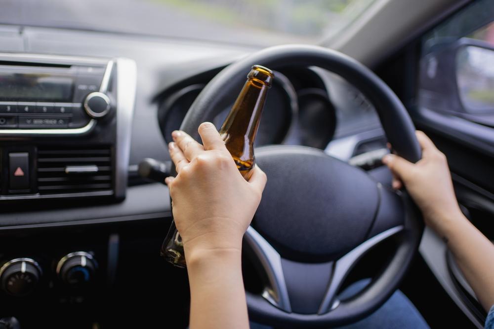 A driver, holding a bottle before a DUI accident. Are there punitive damages for DUI accident cases in Idaho?
