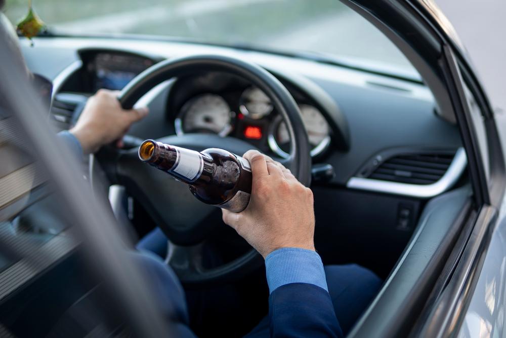 A driver, holding a bottle before a DUI accident. Are there punitive damages for DUI accident cases in Washington?