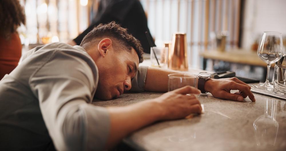 A passed-out man at a bar. What are the dram shop and social host laws in Utah?