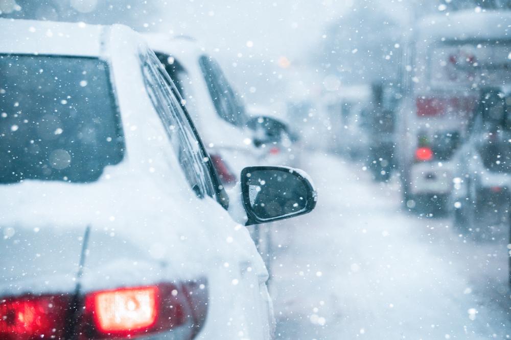 Cars sitting in highway traffic in the snow. How does weather impact car accident claims?
