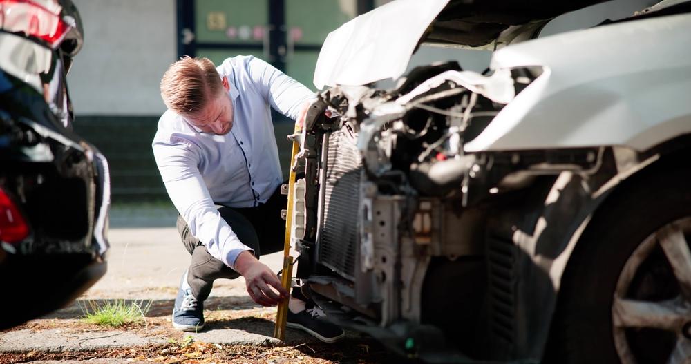 An insurance adjuster creating a crash report in West Jordan, UT.