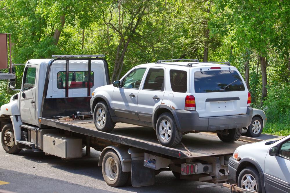 A tow truck towing cars after a multi-vehicle crash. Who is at fault in a multi-vehicle crash?
