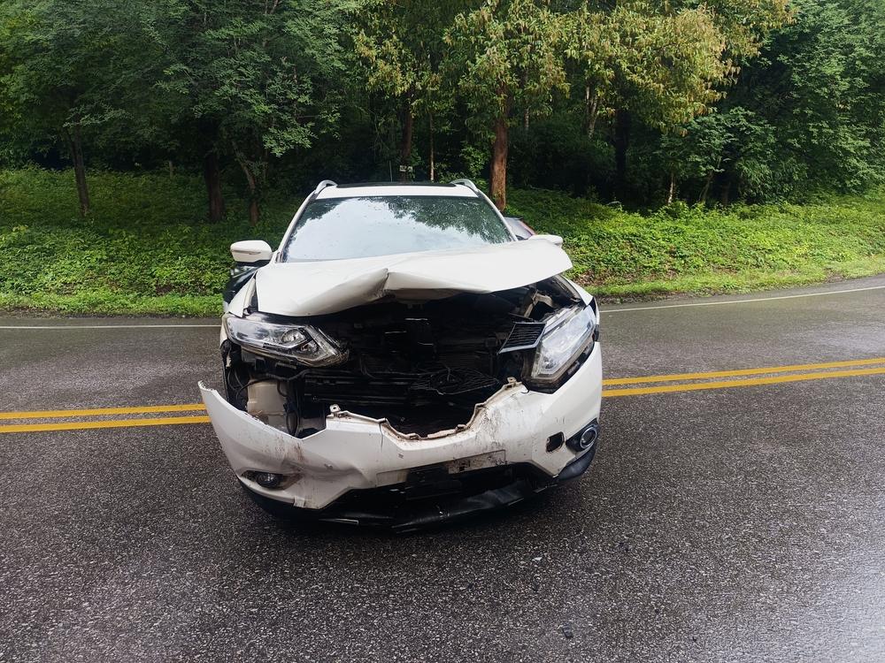 A white car in the middle of the street, damaged from a car accident. IS Washington a no-fault state?