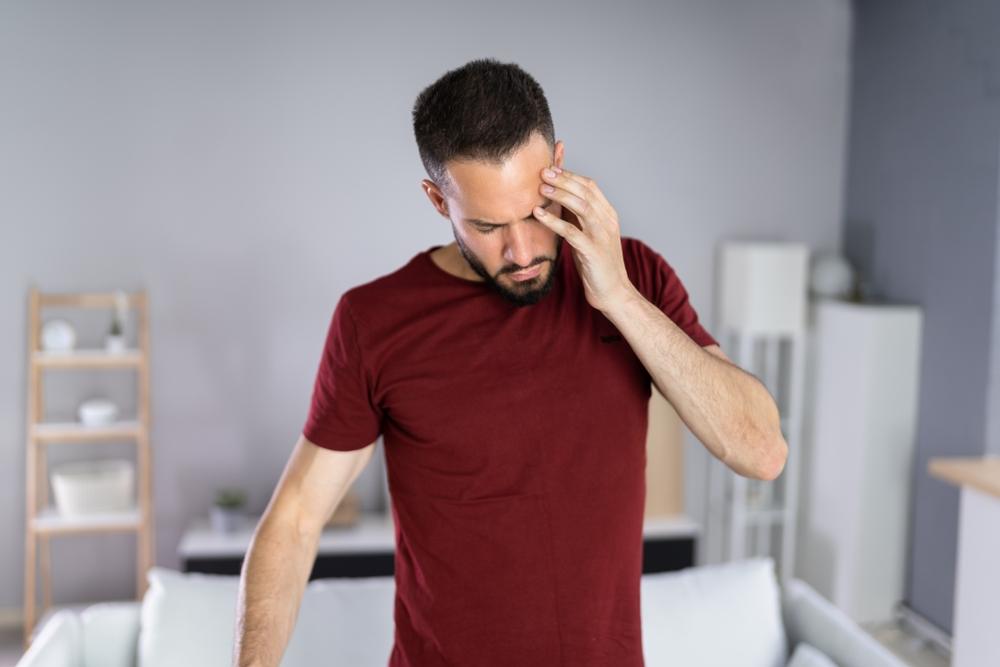 A man holding his head, wondering, “What is the average settlement for a concussion?”