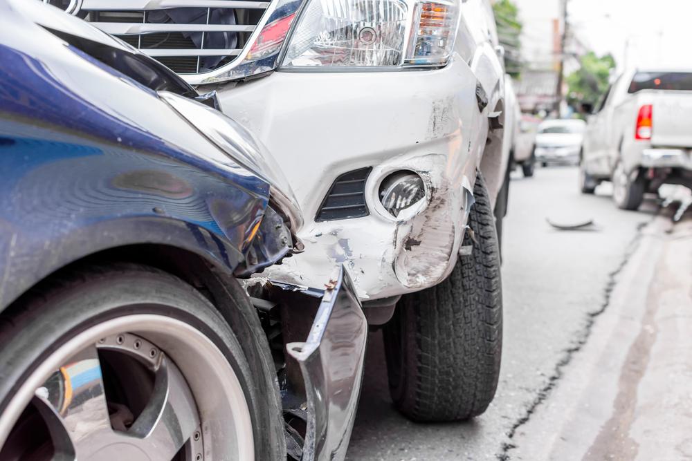 Two smashed front ends of cars after an accident. How to get a car crash report in Nampa, ID.
