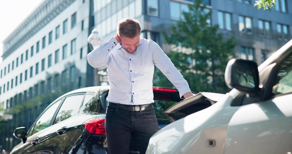 A man holding his neck after a car accident. Are car accident settlements taxable in Utah?