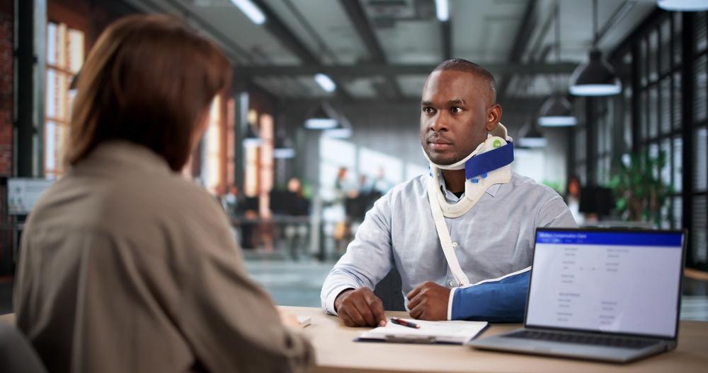 An injured man in a neck brace with a truck accident lawyer. How to find the best truck accident lawyer.